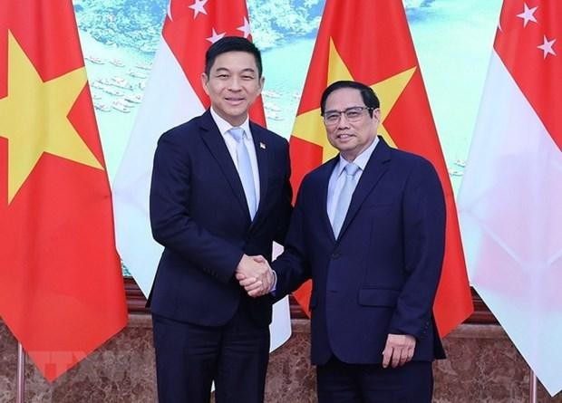 Thủ tướng Phạm Minh Chính và Chủ tịch Quốc hội Singapore Tan Chuan-Jin. Ảnh: TTXVN