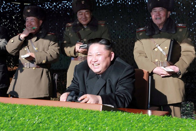 Ông Kim Jong-un và các quan chức quân đội theo dõi một cuộc tập trận (Ảnh: Reuters)