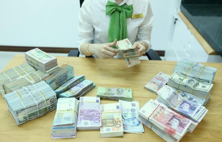 Giá USD tại Vietcombank hôm nay 15/3 tăng 10 đồng. Ảnh minh họa: BNEWS/TTXVN